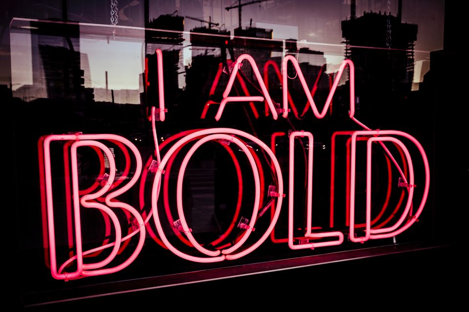 Red neon sign in window reads "I AM BOLD"